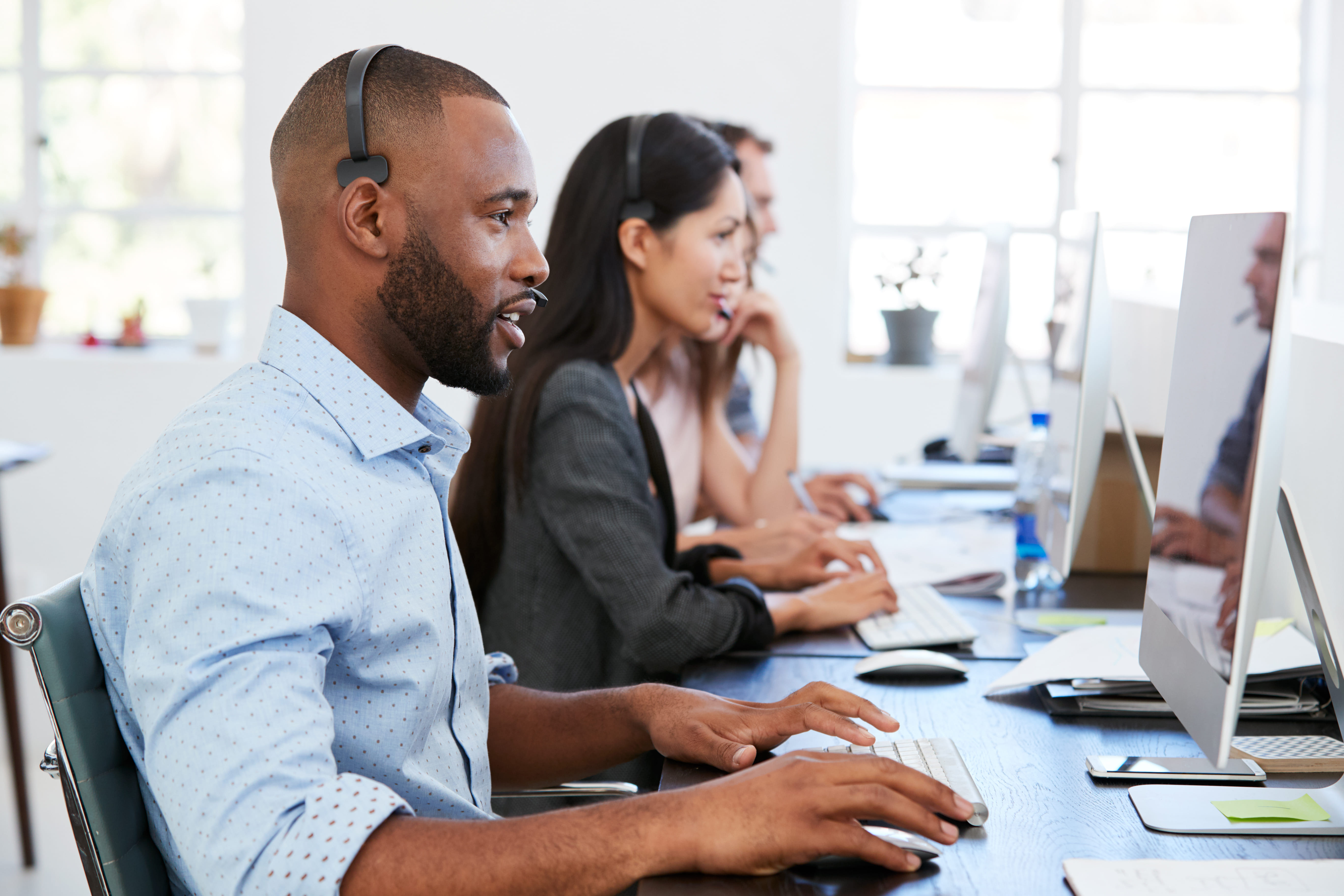 Support agents on headsets in a call recording and QA environment